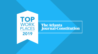 Blue graphic with a white ribbon on the left reading Top Work Places 2019 and text on the right saying The Atlanta Journal-Constitution.