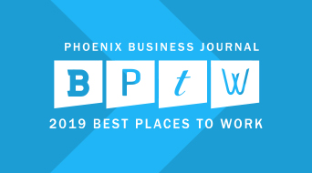 Blue graphic with white text: Phoenix Business Journal BPTW 2019 Best Places to Work. The letters B, P, T, W are individually boxed and stylized.