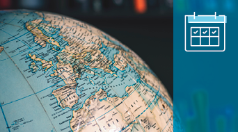 A close-up view of a globe showing parts of Europe and Africa. To the right, there is a blue icon of a calendar with checkmarks indicating selected days. The background is out of focus.