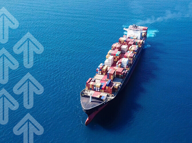 A cargo ship navigates through blue ocean waters, carrying numerous colorful shipping containers. On the left, upward arrows in semi-transparent white suggest growth or progress. The image embodies international freight and maritime trade logistics.