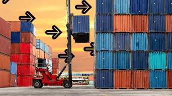 A forklift lifts a blue shipping container among stacks of multicolored containers in a storage yard. Black arrows point to the container being lifted. The sky is a warm orange, suggesting sunset.