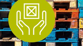 A stack of colorful wooden pallets is in the background. In the foreground, a green circle features a white icon of two hands holding a square container.