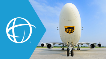 Front view of a large UPS cargo airplane on the runway, with the UPS logo on the nose. To the left is a blue geometric shape featuring a white globe symbol. The sky is clear, indicating a bright day.