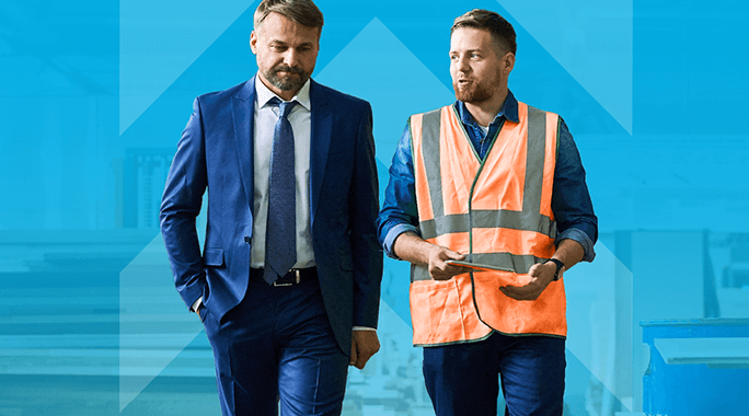 Two men walking and talking. One is in a blue suit and tie, and the other is in a blue shirt with an orange safety vest, holding a tablet. The background is a light blue with an upward arrow design.