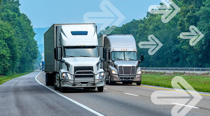 Two large trucks drive side by side on a highway surrounded by green trees, embodying the dynamic flow of Spot vs Contract Freight. White arrows overlay the image, pointing forward, suggesting movement or progress. The sky is blue with a few clouds.