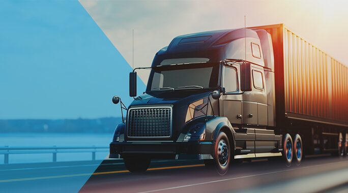 A sleek black semi-truck with a container trailer travels on a highway near a body of water. The image has a split toning effect, with one side in cool blue hues and the other in warm sunlight, highlighting the trucks details.