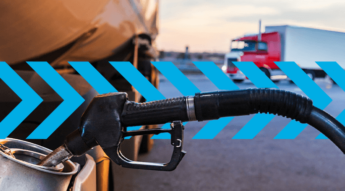 A fuel nozzle filling a vehicles tank in the foreground, with a red truck and a blue chevron graphic overlay in the background.